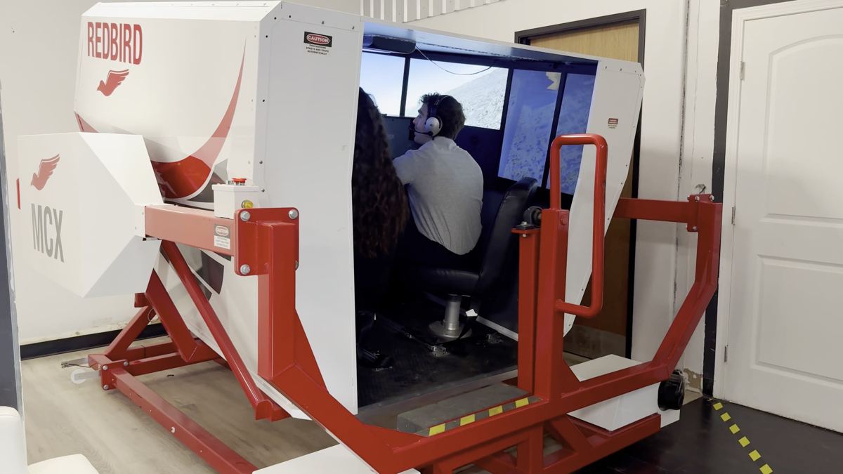 Redbird MCX full-motion flight simulator with a student at the controls at You Fly LA, Van Nuys Airport
