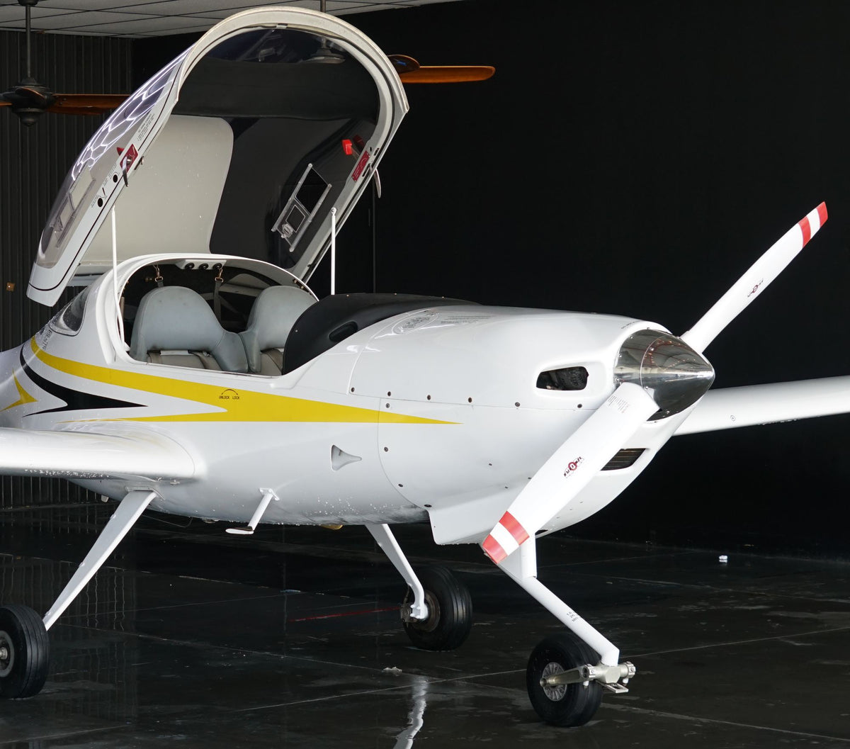 Diamond DA20 with its bubble canopy open in the hangar