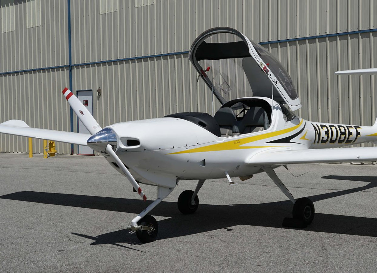 White Diamond DA20 with its canopy open outside the hangar at Van Nuys