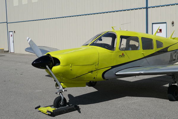Piper Arrow N316EF, front quarter, by the hangar wall