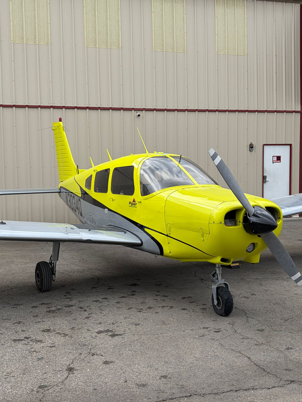 Piper Warrior N3034Q nose and propeller by the hangar