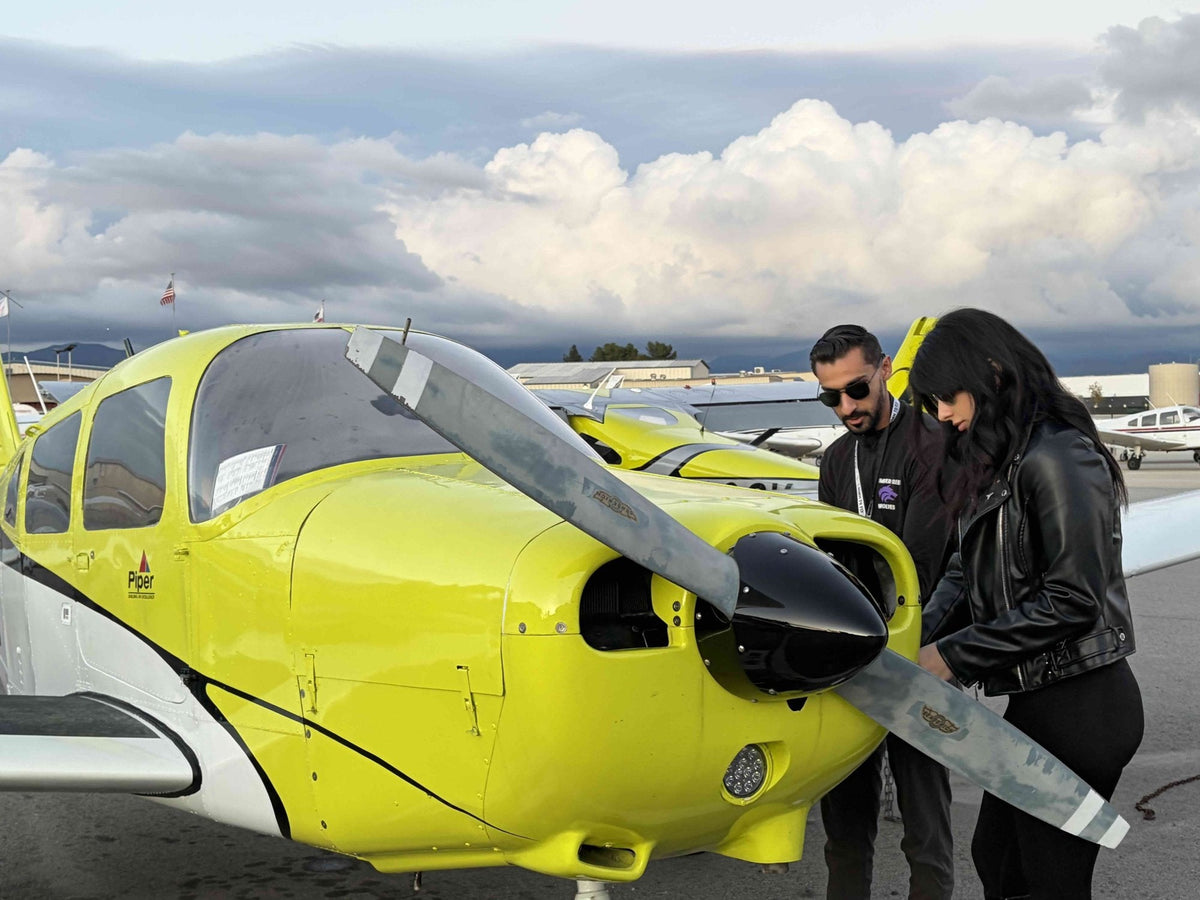 Instructor and student beside a Piper Warrior before a 90-minute discovery flight at Van Nuys Airport, Los Angeles
