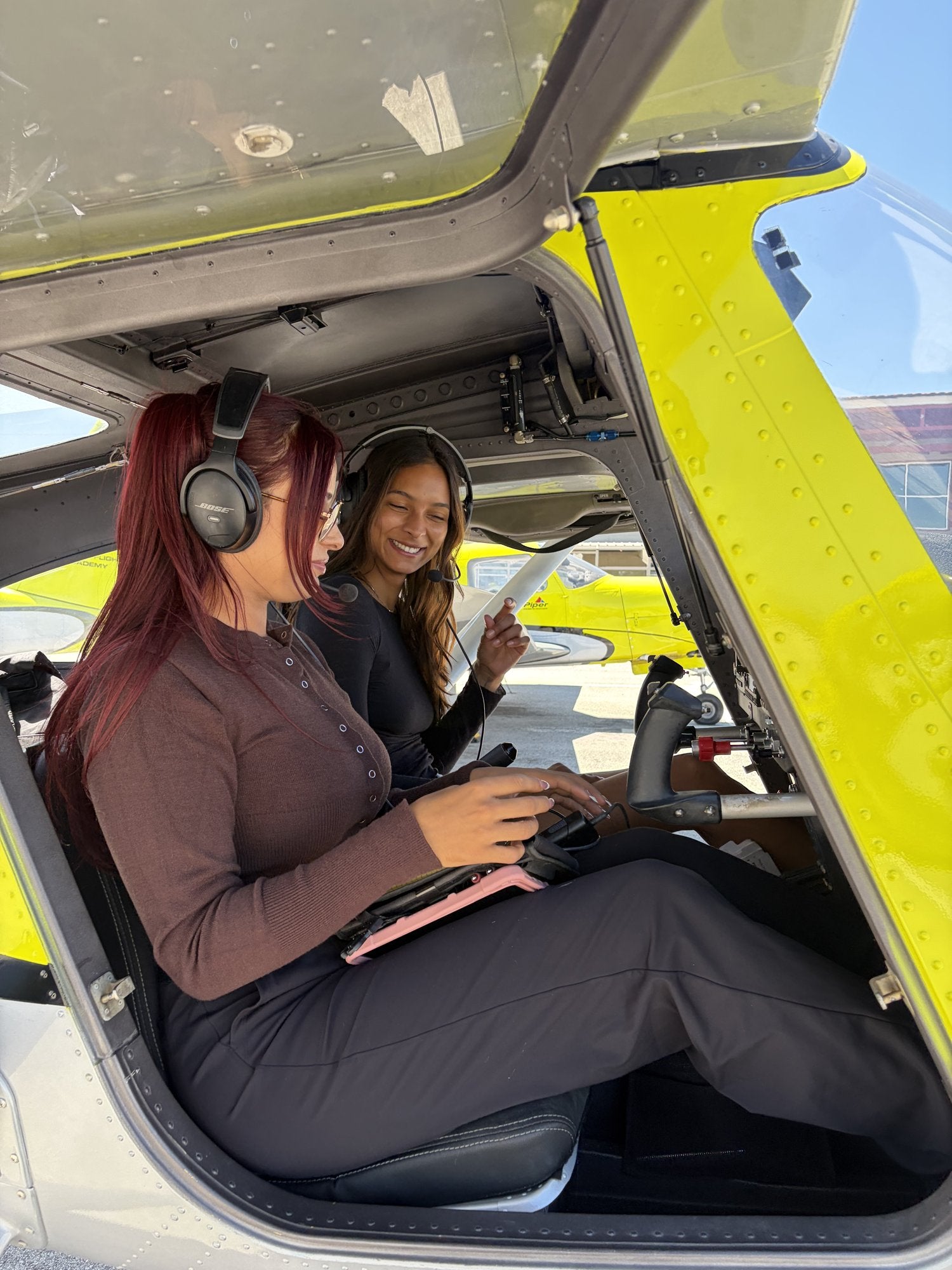 Two flyers in headsets in a Cessna 162 cockpit