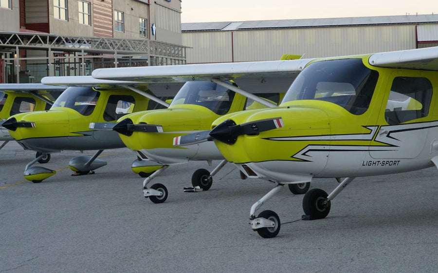 Row of yellow Cessna 162 Skycatcher trainers lined up on the ramp at Van Nuys Airport