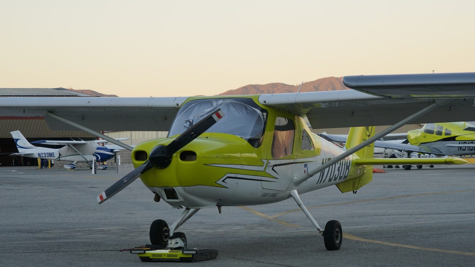 Cessna 162 Skycatcher trainer seen nose first on the Van Nuys ramp at sunset