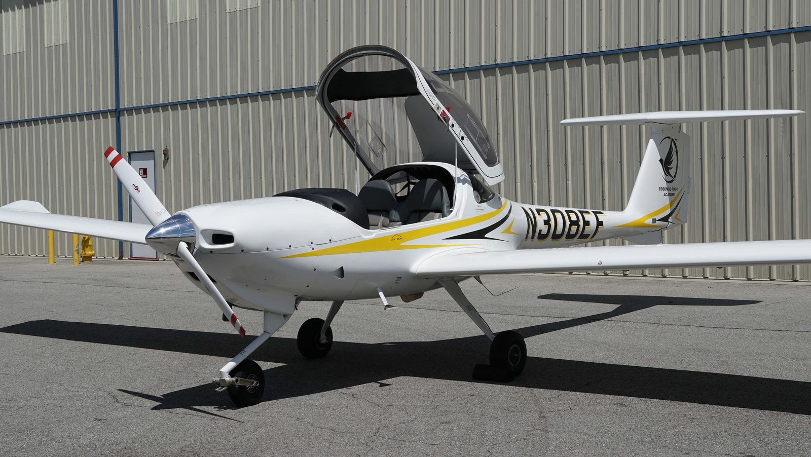 White Diamond DA20 with its canopy open outside the hangar at Van Nuys