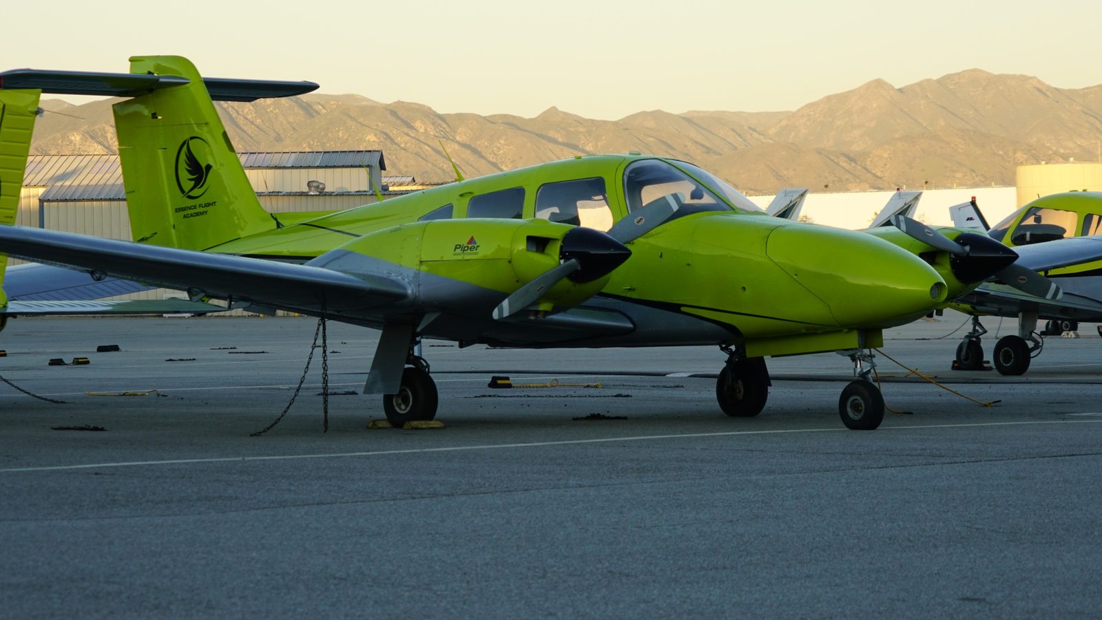 Side view of a Piper Seminole at sunset on the Van Nuys ramp