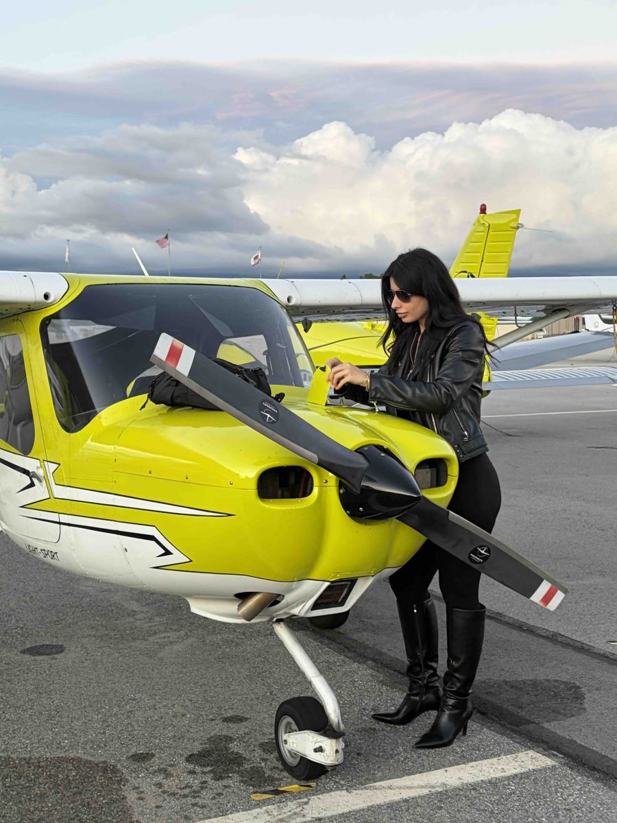 Pilot carrying out a preflight walkaround inspection of a Cirrus at Van Nuys